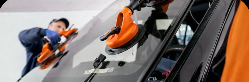 A windshield being set in place with suction cups